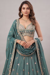 Deep Rama Tissue Lehenga Choli with Scenic Peacock & Animal Motif Embroidery