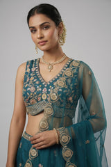 Teal Blue Tissue Lehenga Choli with Scalloped Jharokha and Peacock Embroidery
