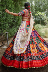 The Rajwadi Patola Silk Lehenga Ensemble With Scalloped V-Neck Hand-Embellished Blouse And Sheer Organza Tissue Dupatta
