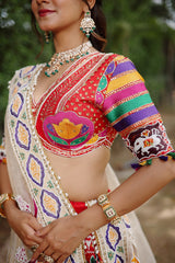The Rajwadi Patola Silk Lehenga Ensemble With Scalloped V-Neck Hand-Embellished Blouse And Sheer Organza Tissue Dupatta