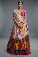 The Rajwadi Patola Silk Lehenga Ensemble With Scalloped V-Neck Hand-Embellished Blouse And Sheer Organza Tissue Dupatta