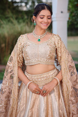 The Imperial Gold Jacquard Brocade Woven Silk Kalidar Lehenga Ensemble with Handcrafted Jewel Blouse and All-Over Cutwork Tissue Dupatta