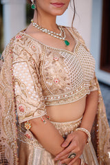 The Imperial Gold Jacquard Brocade Woven Silk Kalidar Lehenga Ensemble with Handcrafted Jewel Blouse and All-Over Cutwork Tissue Dupatta