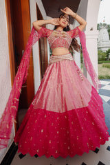 The Fuchsia Pink Ombre Tissue Lehenga Ensemble with High-Neck Keyhole Blouse and Floor-Length Feather Cape Sleeves