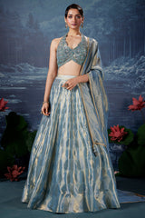Powder Blue Tissue Silk Zari Woven Lehenga with Handworked Halter Neck Blouse