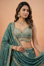 Deep Rama Tissue Lehenga Choli with Scenic Peacock & Animal Motif Embroidery