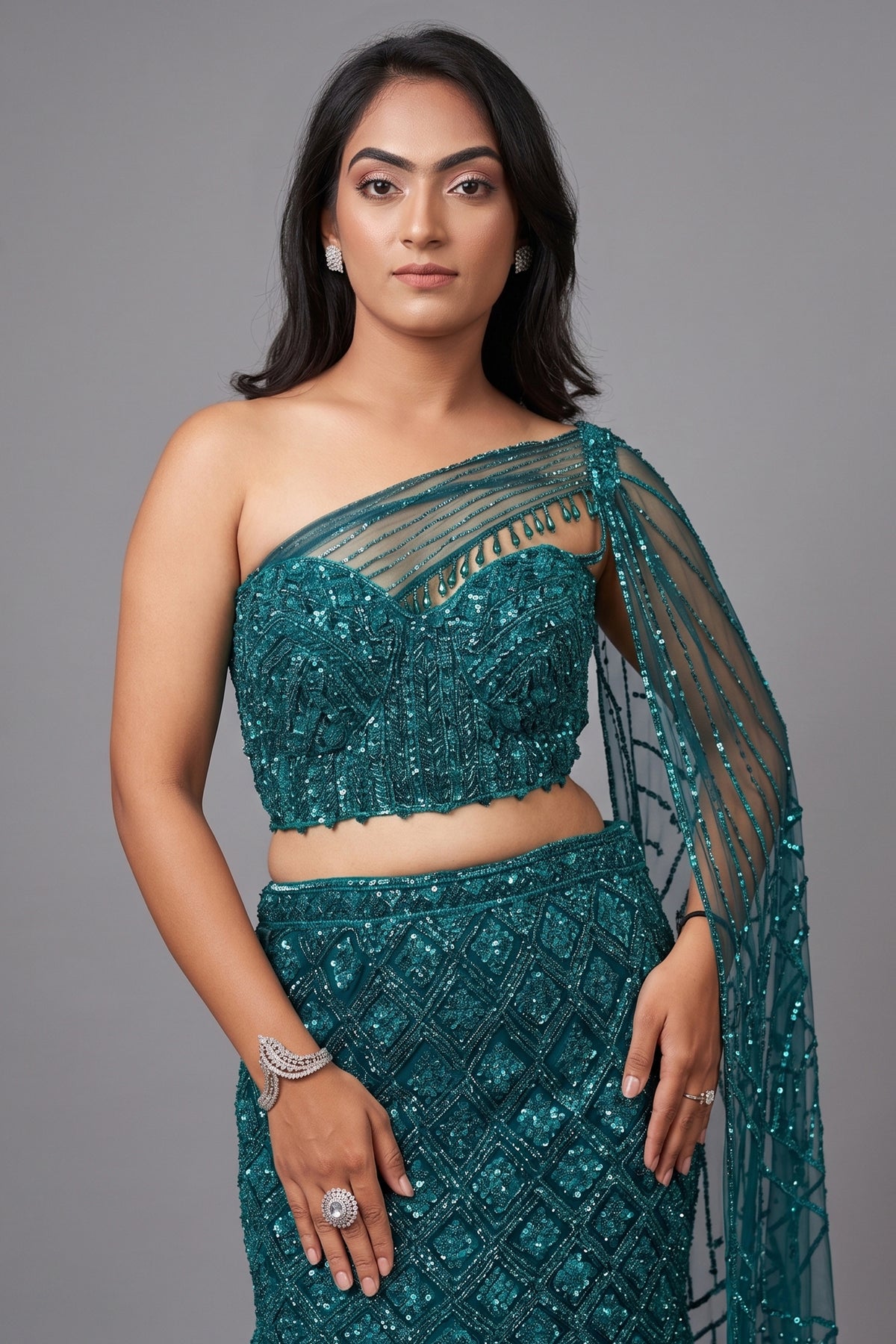 Teal Blue Net Embellishment Fish Cut Sequin Cutdana Work Lehenga with One Shoulder Cape Corset