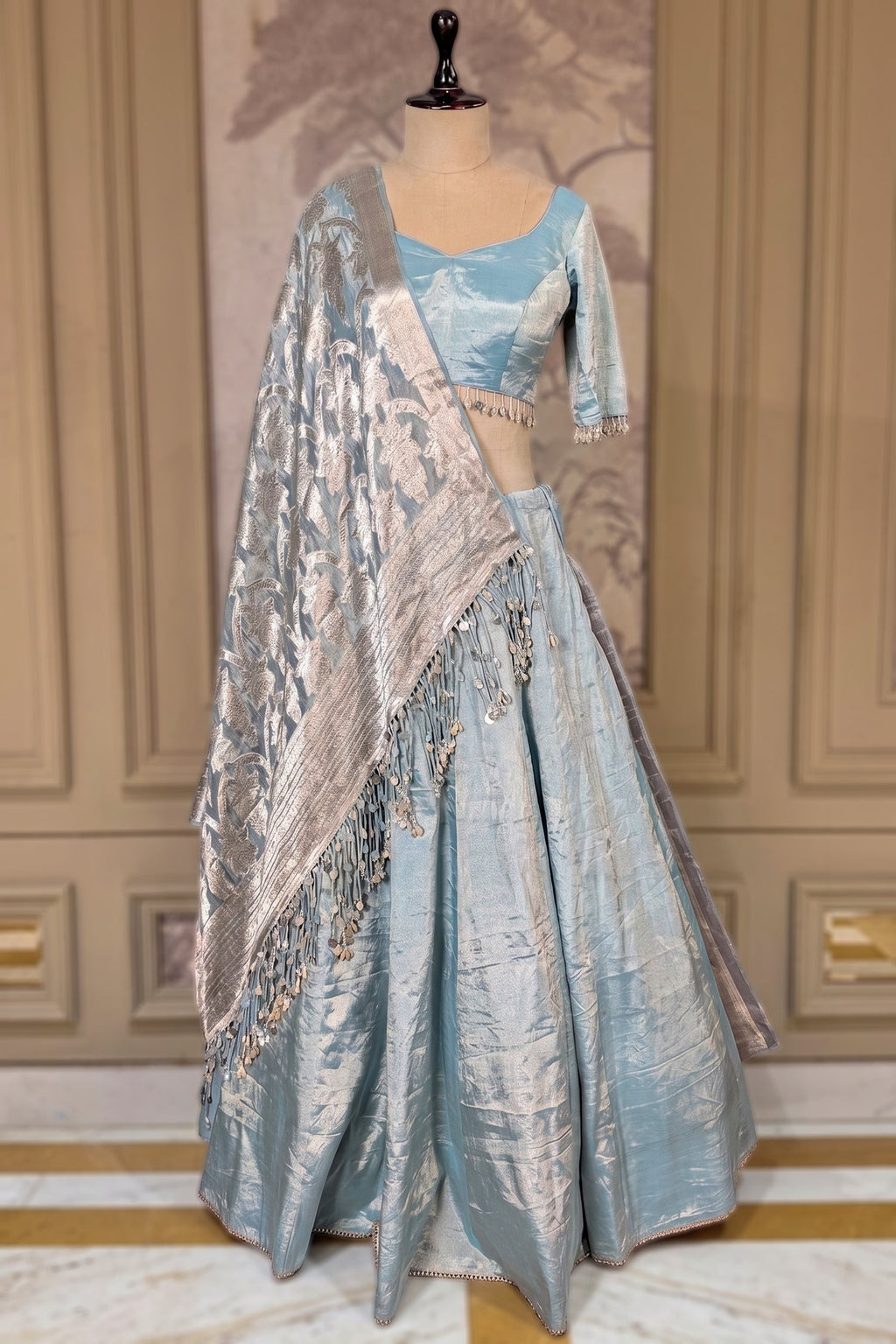 Icy Blue Metallic Tissue Silk Minimalist Lehenga Choli with Woven Banarasi Dupatta and Cowrie Shell Tassels