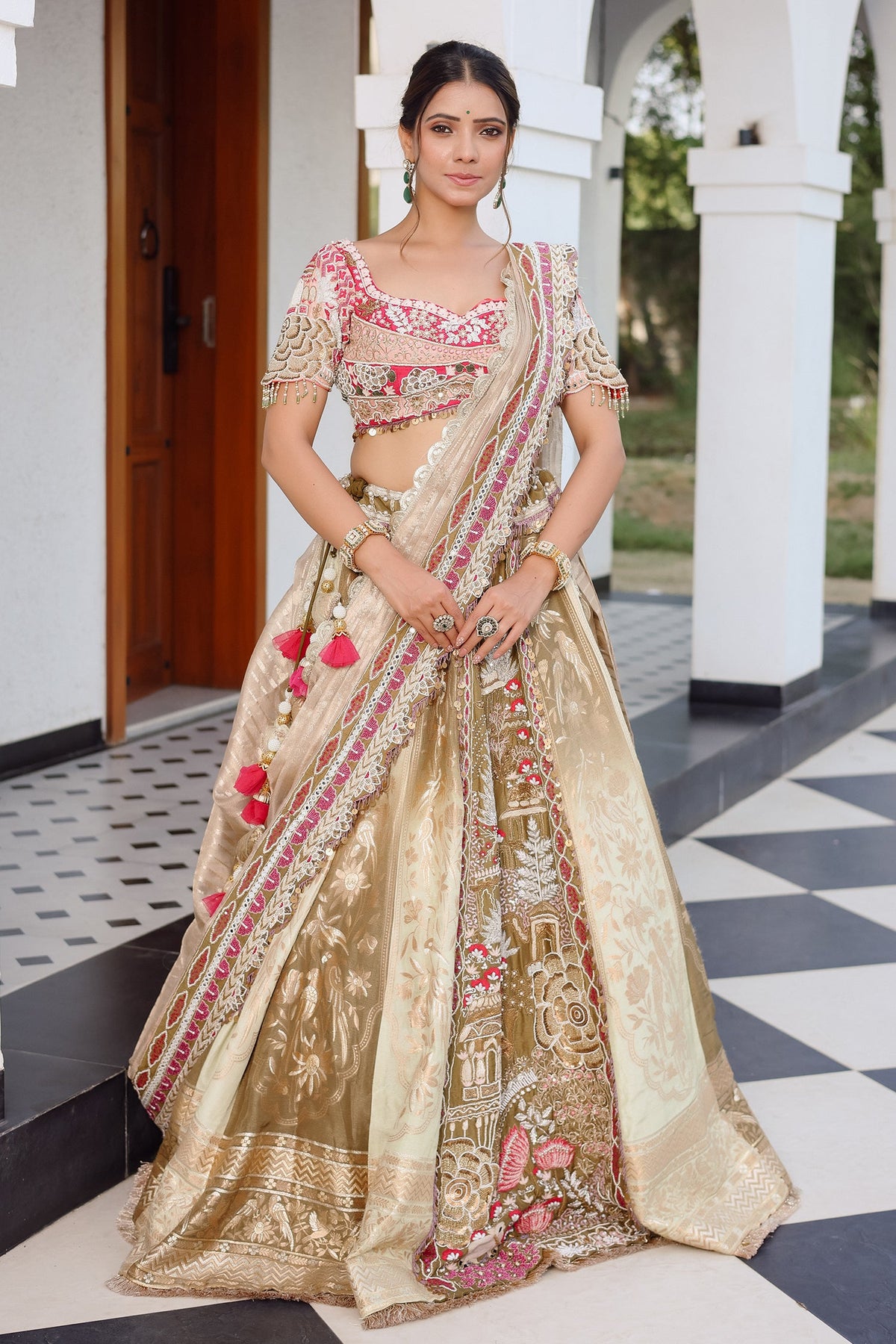 The Olive Green Shaded Brocade Silk Woven Lehenga Ensemble with Jharokha Embroidered Sweetheart Blouse and Attached Organza Dupatta
