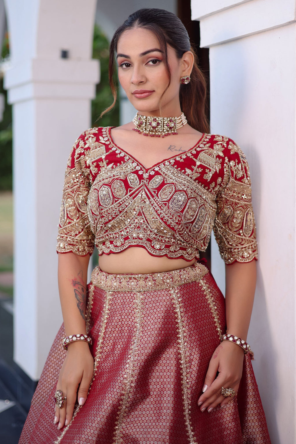 The Majestic Maroon Banarasi Silk Bridal Lehenga Ensemble with Jharokha Zardosi Blouse and Sheer Scalloped Veil