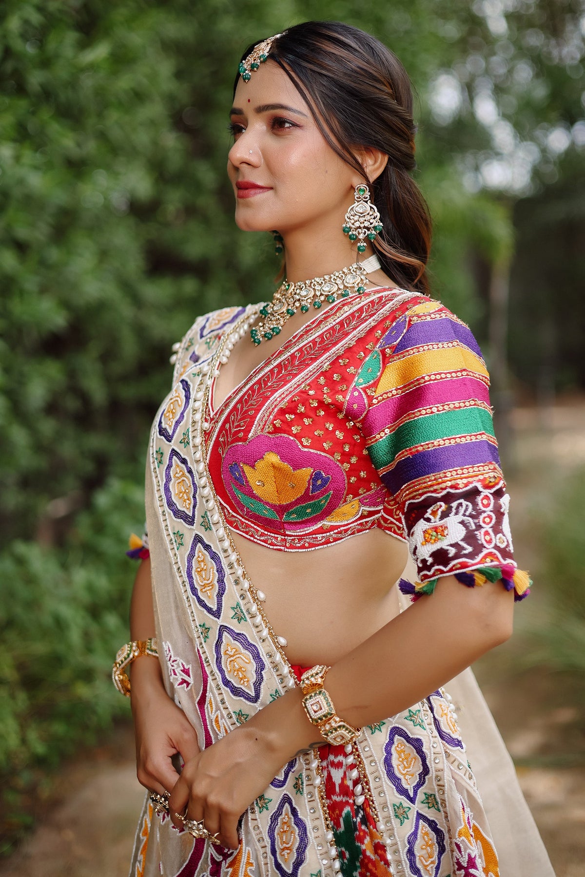 The Rajwadi Patola Silk Lehenga Ensemble With Scalloped V-Neck Hand-Embellished Blouse And Sheer Organza Tissue Dupatta
