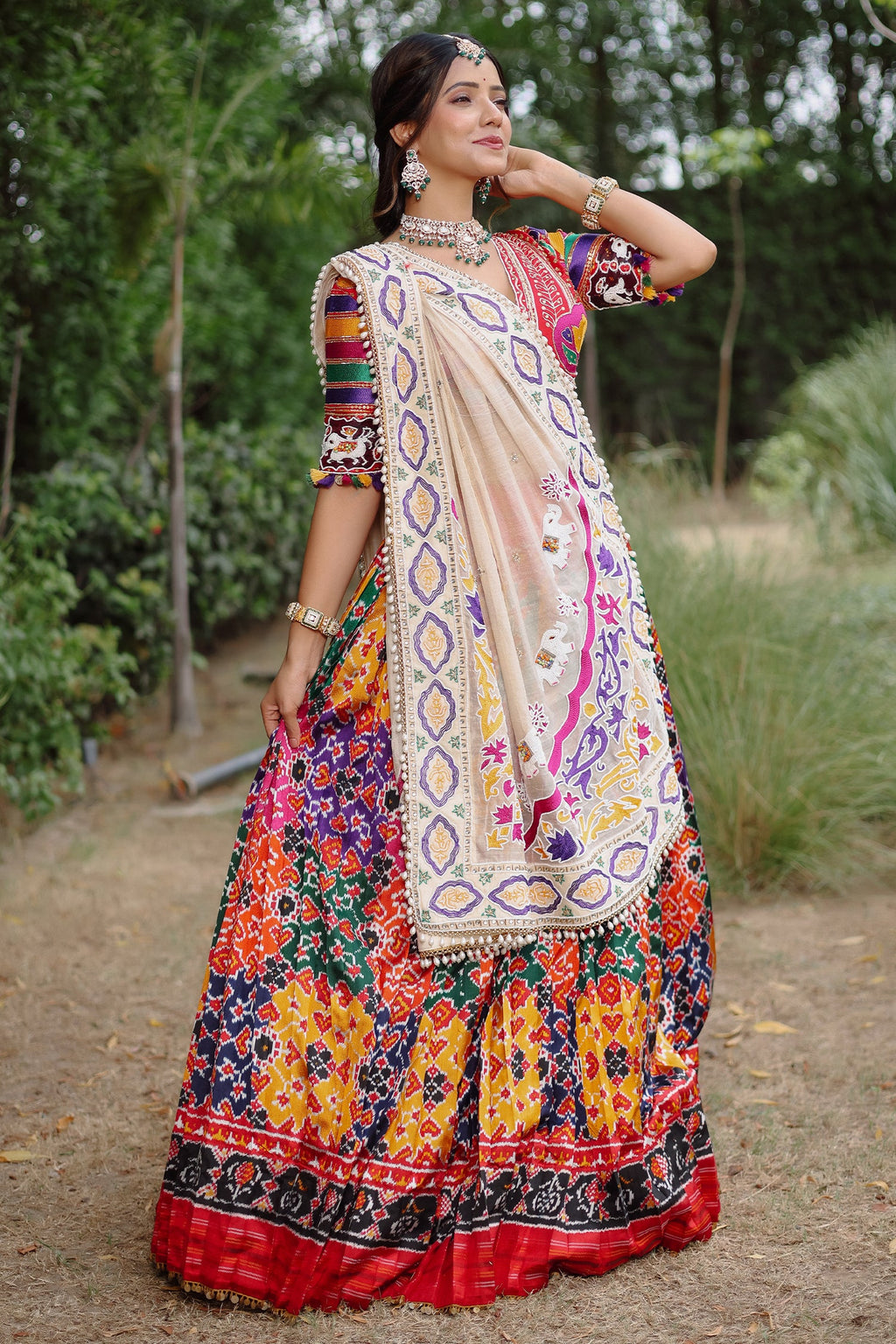 The Rajwadi Patola Silk Lehenga Ensemble With Scalloped V-Neck Hand-Embellished Blouse And Sheer Organza Tissue Dupatta
