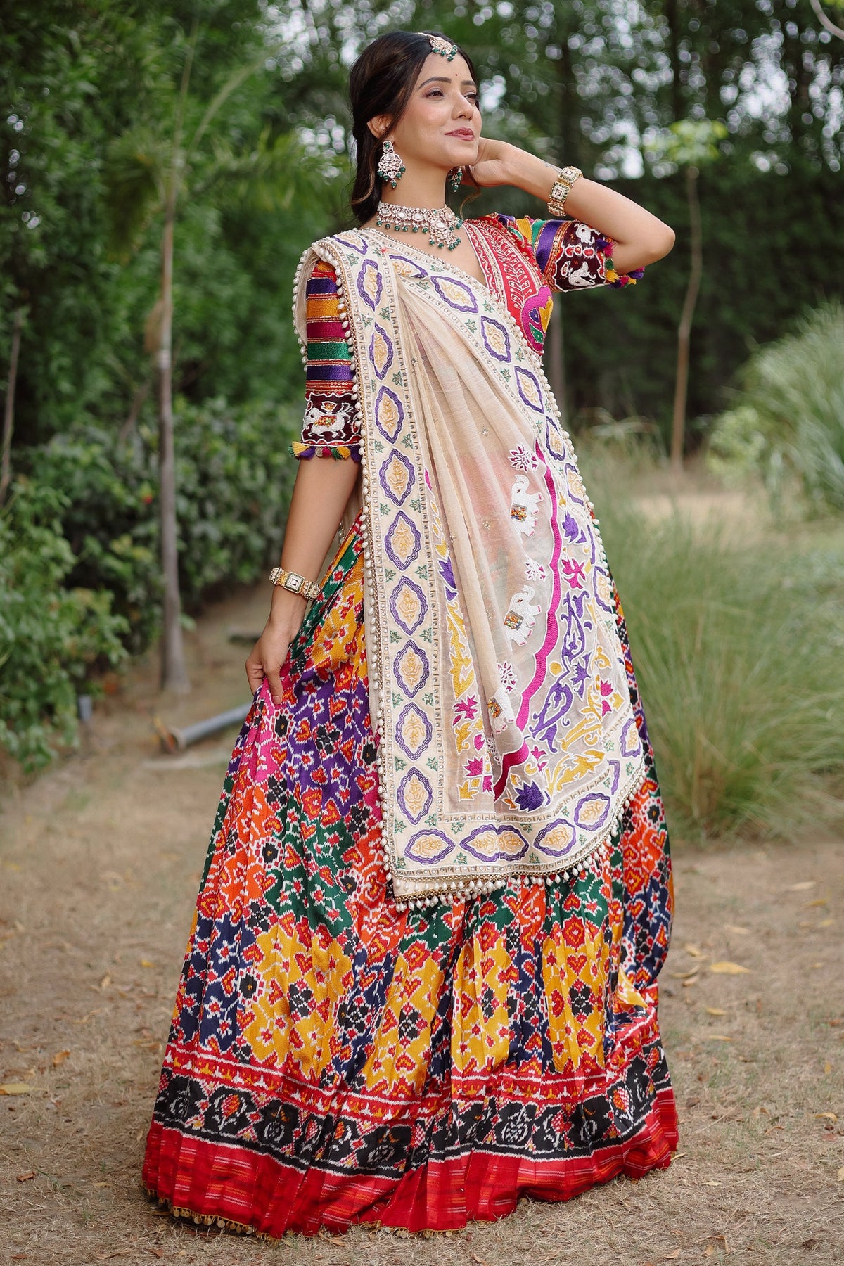 The Rajwadi Patola Silk Lehenga Ensemble With Scalloped V-Neck Hand-Embellished Blouse And Sheer Organza Tissue Dupatta
