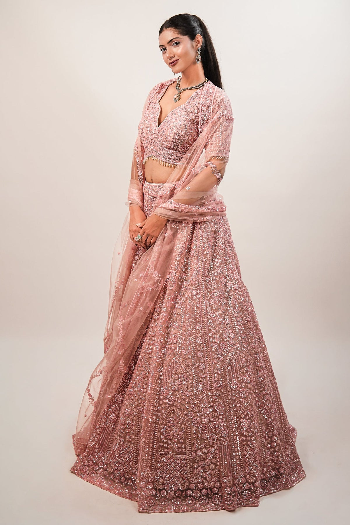 Blossom Pink Net Lehenga featuring Hand-Embellished V-Neck Blouse with Hanging Beads