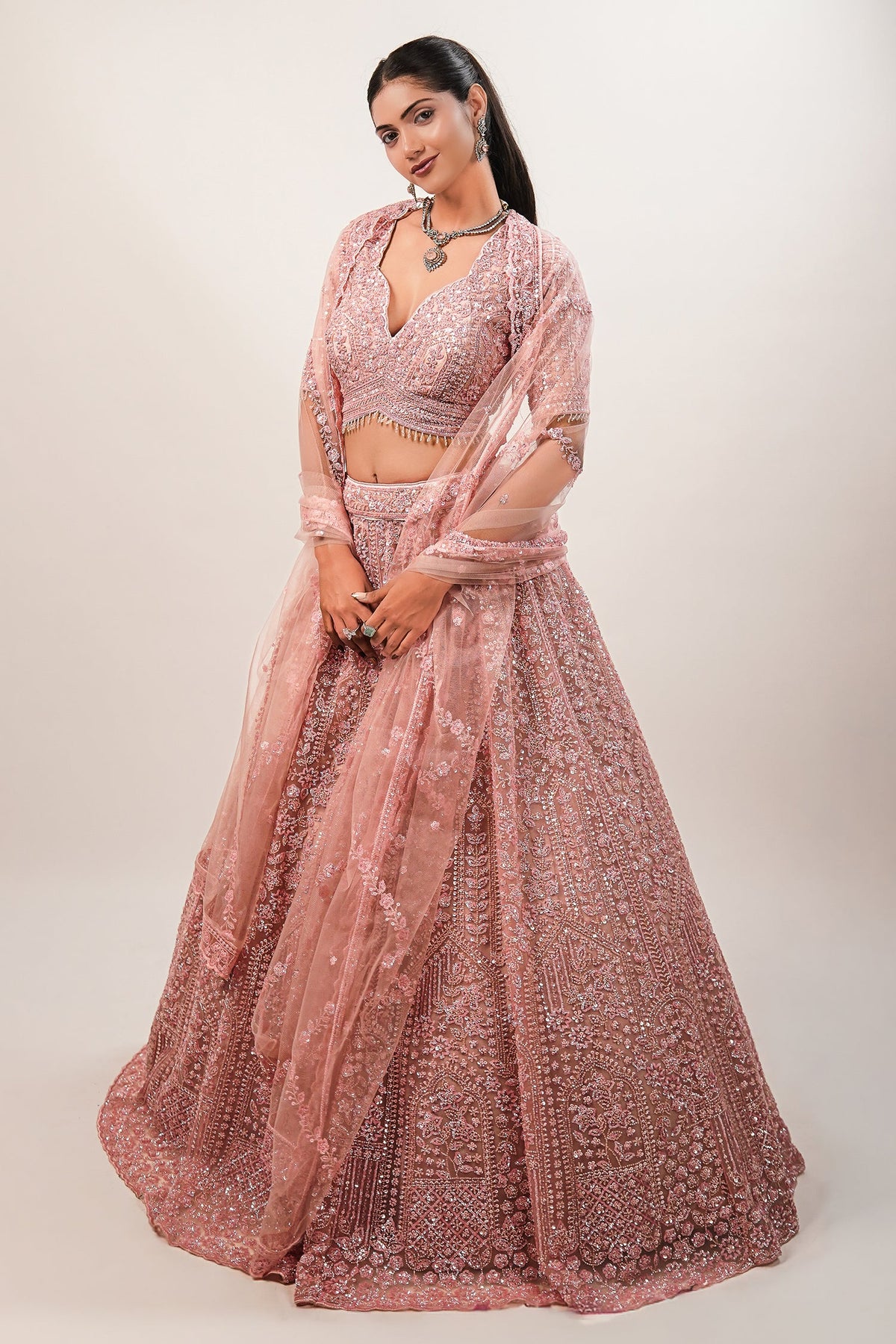 Blossom Pink Net Lehenga featuring Hand-Embellished V-Neck Blouse with Hanging Beads