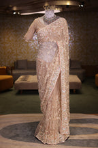 Beige Net Designer Saree Enriched With Glamorous Sequins And Cutdana Hand Embroidery