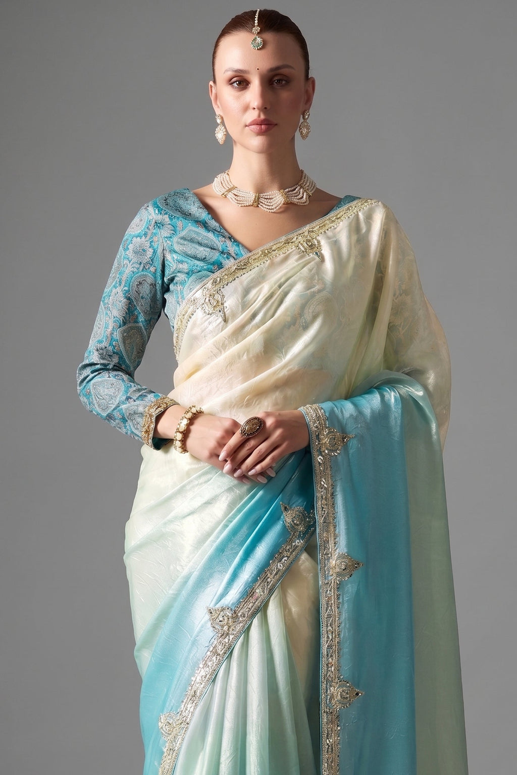 Ombre Sky Blue Tissue Saree Embellished With Sequins And Paired With A Matching Azure Print Blouse.