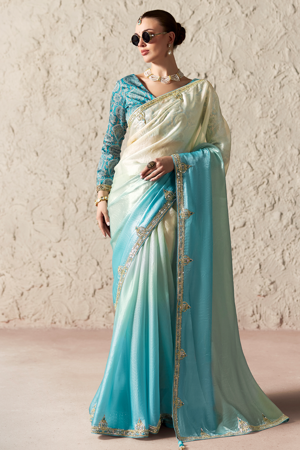 Ombre Sky Blue Tissue Saree Embellished With Sequins And Paired With A Matching Azure Print Blouse.