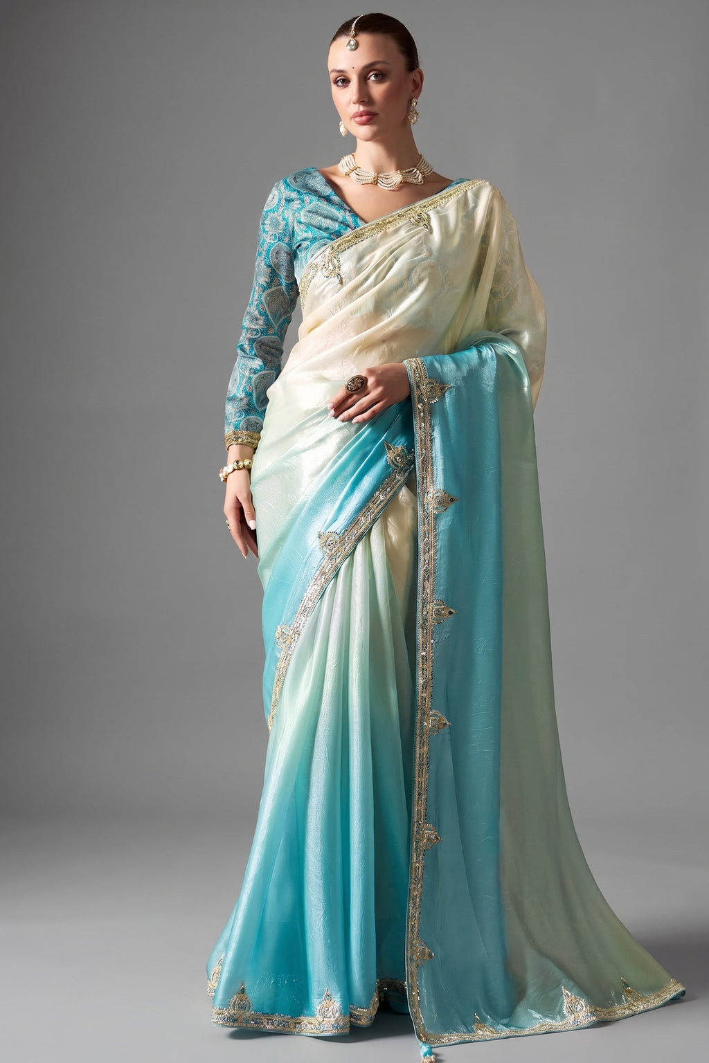 Ombre Sky Blue Tissue Saree Embellished With Sequins And Paired With A Matching Azure Print Blouse.