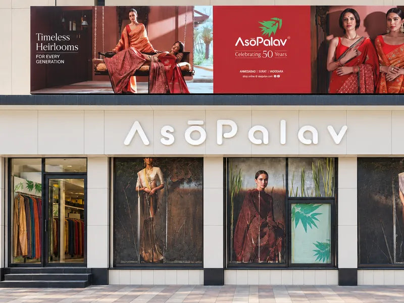 Asopalav Ashram Road storefront with its illuminated wordmark and fashion displays