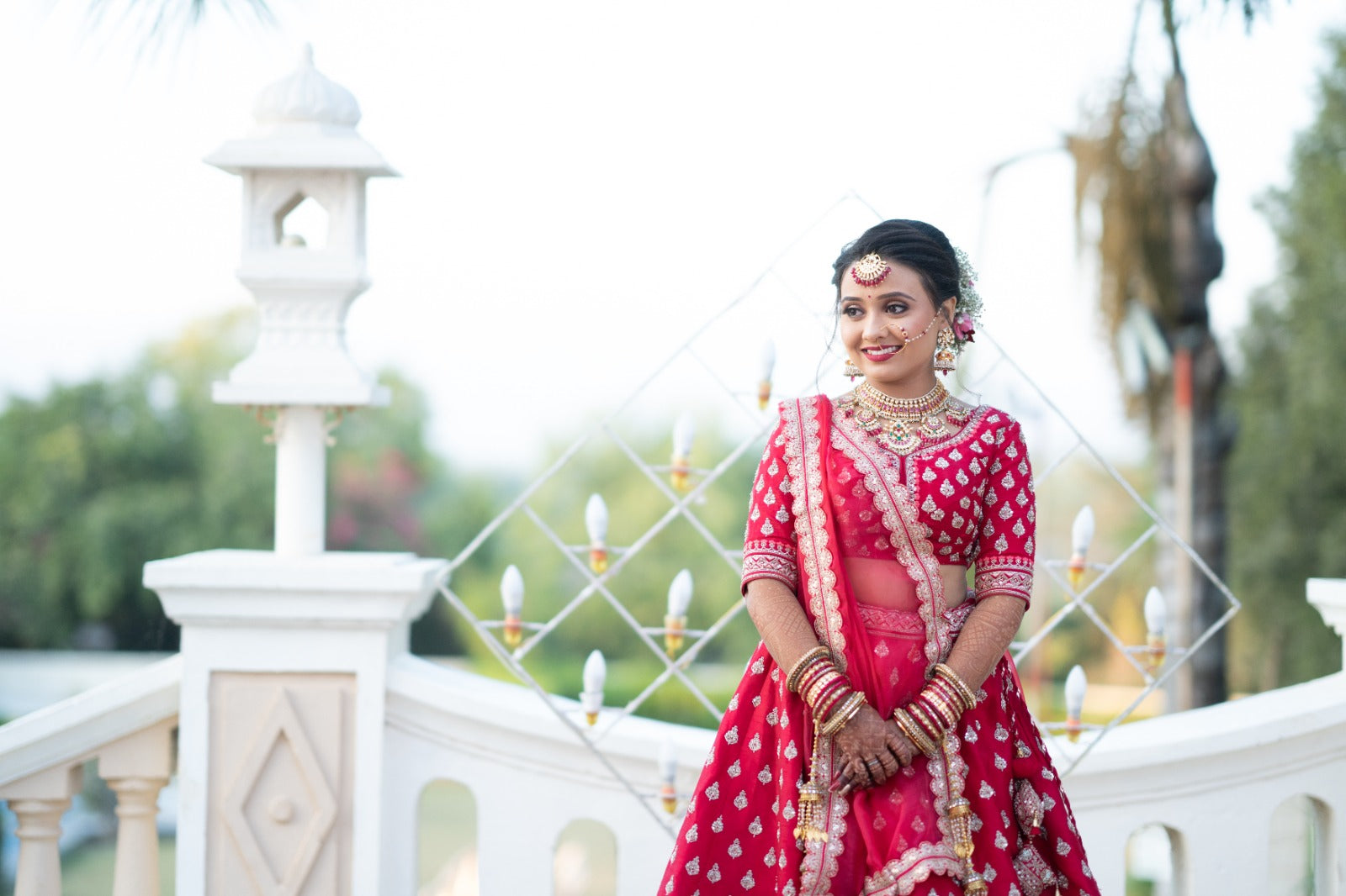 Asopalav bride in a red bridal lehenga at an outdoor celebration